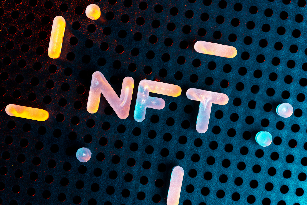 NFT nonfungible tokens text from letters glowing with neon light on a dark background